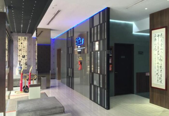 Bliss Hotel Singapore lobby. Gay-friendly hotel with modern design, blue lighting, and Asian-inspired decor. A comfortable and welcoming space.