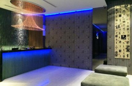 Bliss Hotel Singapore lobby. Gay-friendly hotel with modern design, blue lighting, and unique chandelier. A stylish stay for gay travelers.