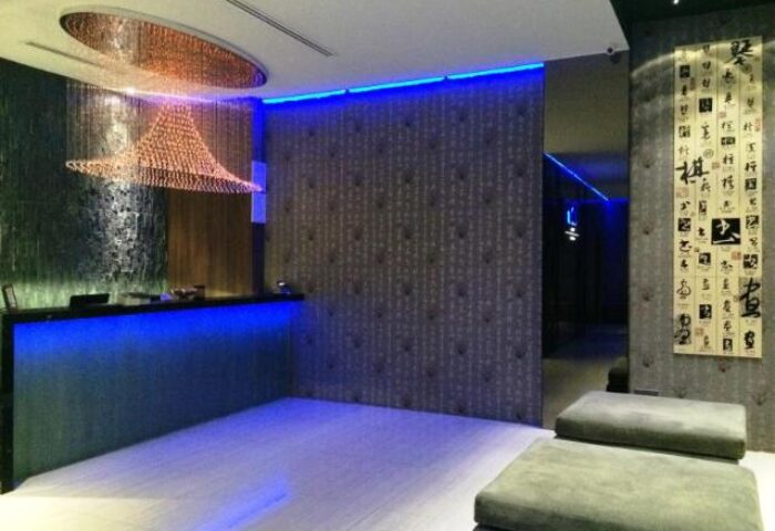 Bliss Hotel Singapore lobby. Gay-friendly hotel with modern design, blue lighting, and unique chandelier. A stylish stay for gay travelers.