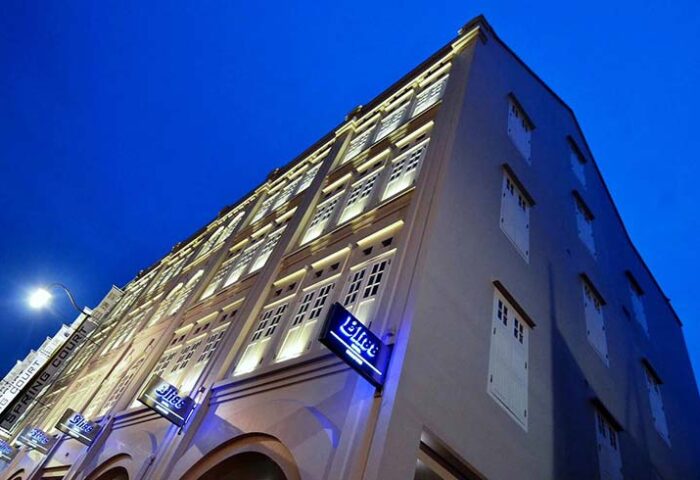 Exterior of Bliss Hotel Singapore, a gay-friendly hotel, at night. Building facade with illuminated windows and signage. Ideal for gay travel.