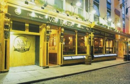 Blooms Hotel, a gay-friendly hotel, features the Vat House Bar in Temple Bar, Dublin. The bar's exterior is illuminated at night.