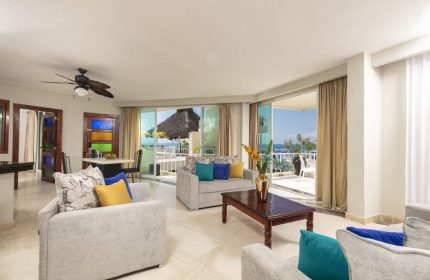 Living area at the gay-friendly Blue Chairs Resort by the Sea, an adults-only hotel. Balcony view of the ocean. Modern, bright interior.