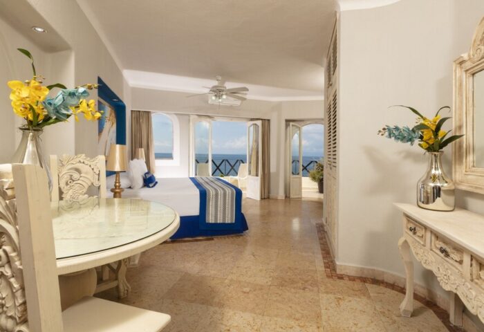 Blue Chairs Resort by the Sea Adults Only gay-friendly hotel room. Ocean view from balcony, ornate table, and luxury decor.