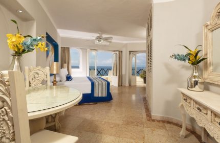 Blue Chairs Resort by the Sea Adults Only gay-friendly hotel room. Ocean view from balcony, ornate table, and luxury decor.