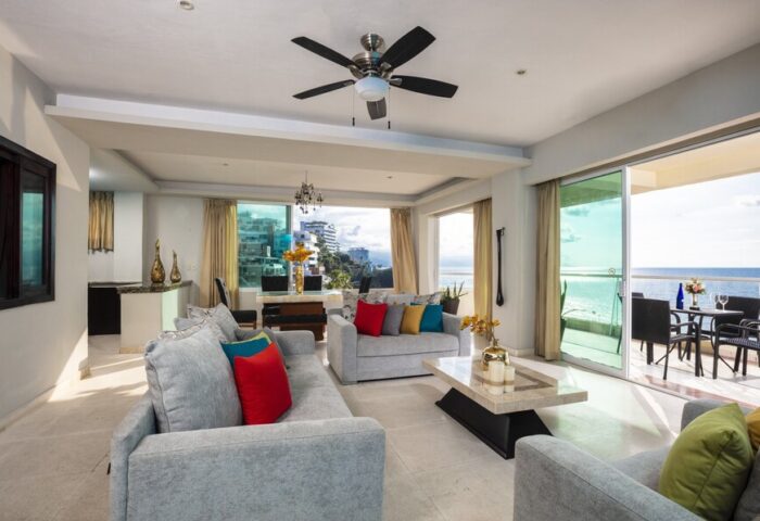Living room at gay-friendly Blue Chairs Resort by the Sea Adults Only. Ocean view, balcony, sofas, and modern decor. Gay travel.