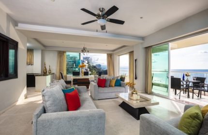 Living room at gay-friendly Blue Chairs Resort by the Sea Adults Only. Ocean view, balcony, sofas, and modern decor. Gay travel.