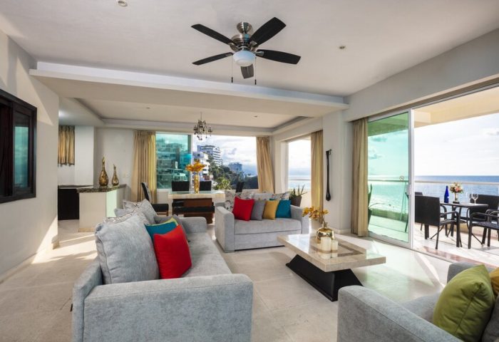 Living room at gay-friendly Blue Chairs Resort by the Sea Adults Only. Ocean view, balcony, sofas, and modern decor. Gay travel.