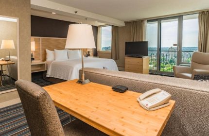 Blue Horizon Hotel room. Gay-friendly hotel with bed, desk, TV, and city view. Comfortable stay for gay travelers. Vancouver hotel room.