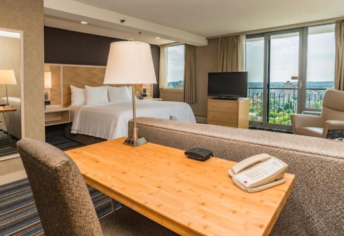 Blue Horizon Hotel room. Gay-friendly hotel with bed, desk, TV, and city view. Comfortable stay for gay travelers. Vancouver hotel room.
