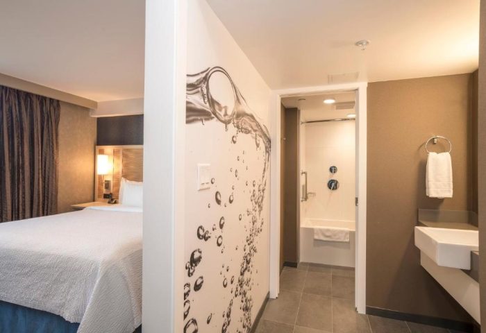 Blue Horizon Hotel gay-friendly room. Clean, modern design with a bed, bathroom, and unique water-themed wall art. Ideal for gay travelers.