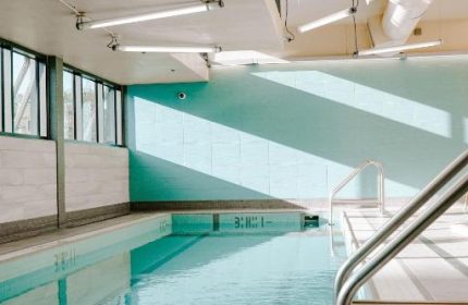 Indoor pool at the gay-friendly Blue Horizon Hotel. Calm water reflects light. A relaxing space for gay travelers. #gaytravel #hotel