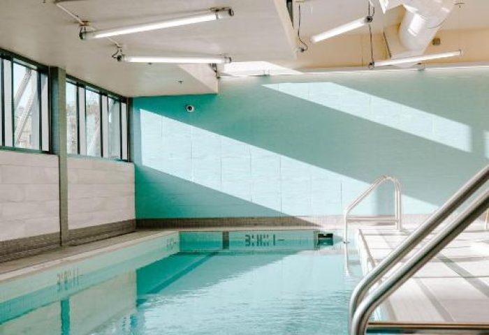 Indoor pool at the gay-friendly Blue Horizon Hotel. Calm water reflects light. A relaxing space for gay travelers. #gaytravel #hotel
