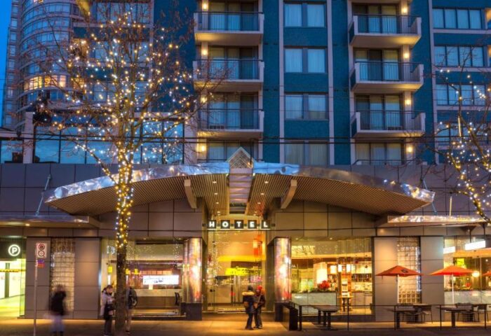 Blue Horizon Hotel, a gay-friendly hotel. Exterior view at dusk with trees decorated with lights. A great choice for gay travel.
