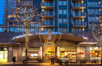Blue Horizon Hotel, a gay-friendly hotel. Exterior view at dusk with trees decorated with lights. A great choice for gay travel.