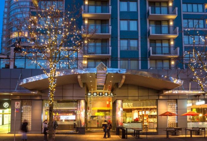 Blue Horizon Hotel, a gay-friendly hotel. Exterior view at dusk with trees decorated with lights. A great choice for gay travel.