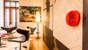 Bohem Art Hotel interior. Gay-friendly hotel features modern art, stylish chairs, and a You Are Here map. Ideal for gay men's travel in Budapest.