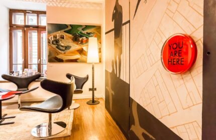 Bohem Art Hotel interior. Gay-friendly hotel features modern art, stylish chairs, and a You Are Here map. Ideal for gay men's travel in Budapest.