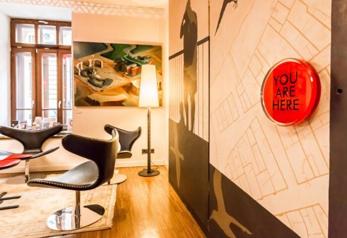 Bohem Art Hotel interior. Gay-friendly hotel features modern art, stylish chairs, and a You Are Here map. Ideal for gay men's travel in Budapest.