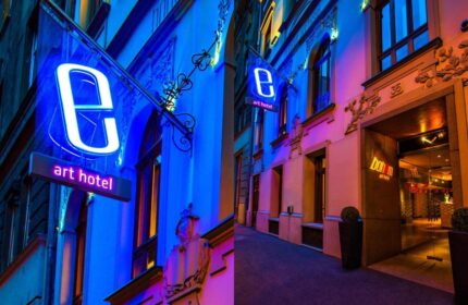 Bohem Art Hotel, a gay-friendly hotel. Exterior view at night with neon sign. A great choice for gay men travel.