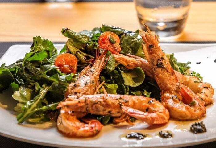 Gourmet shrimp salad at Boheme Mykonos Hotel, an adults-only, gay-friendly destination. Fresh seafood and greens for discerning travelers.