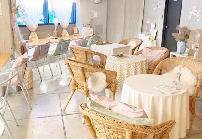 Book Tea Bed SHINJUKU-GYOEN interior. Gay-friendly hotel's tea room with wicker chairs, round tables, & natural light. Cozy, inviting space.