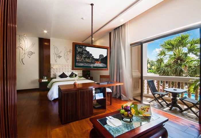 Borei Angkor Resort & Spa room. Gay-friendly hotel with balcony, TV, and desk. Luxury travel for gay men in Siem Reap, Cambodia.