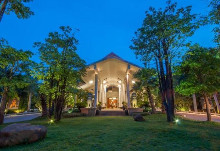 Borei Angkor Resort & Spa entrance at dusk. A gay-friendly hotel with lush gardens, offering a relaxing stay near Angkor Wat, Cambodia.