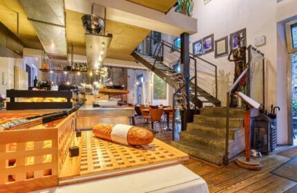 Gay-Friendly Boutique Hotel 026 Koln St. Michael: Interior view showcasing breakfast buffet, stairs, and unique design elements.
