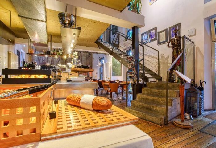 Gay-Friendly Boutique Hotel 026 Koln St. Michael: Interior view showcasing breakfast buffet, stairs, and unique design elements.