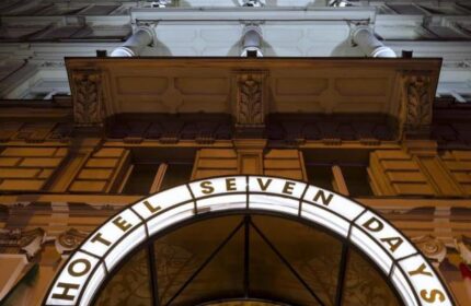 Facade of the Gay-Friendly Hotel Boutique Hotel Seven Days. Illuminated sign with the hotel's name. Travel advice for gay men.