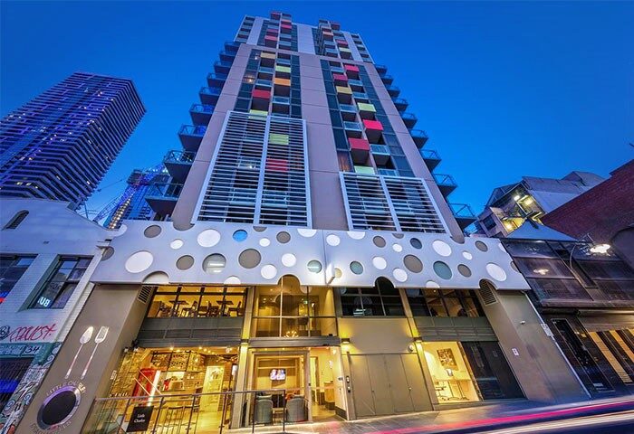 Brady Hotels Central Melbourne exterior view. Gay-friendly hotel with colorful balconies. Modern architecture in Melbourne's city center.