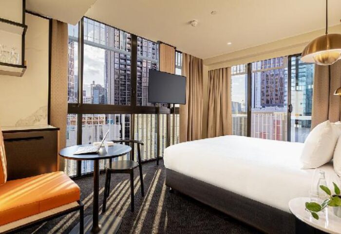 Brady Hotels Jones Lane gay-friendly hotel room. Modern design, city view, bed, desk, chair, and TV. Ideal for gay men travel.