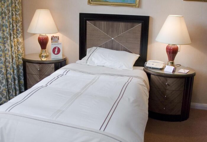 Britannia Manchester Hotel gay-friendly room. Single bed with bedside tables and lamps. Comfortable stay for gay travelers in Manchester.