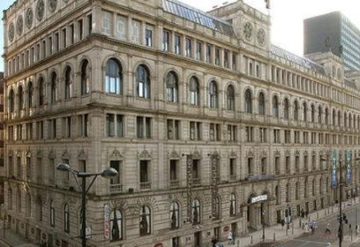 Exterior view of the Gay-Friendly Britannia Manchester Hotel. The hotel is a large, ornate building with many windows. Great choice for gay travel.
