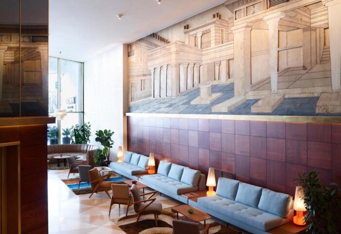 Brown Acropol, a member of Brown Hotels: Gay-friendly hotel lobby with Acropolis mural, blue sofas, and stylish design. Gay travel advice.