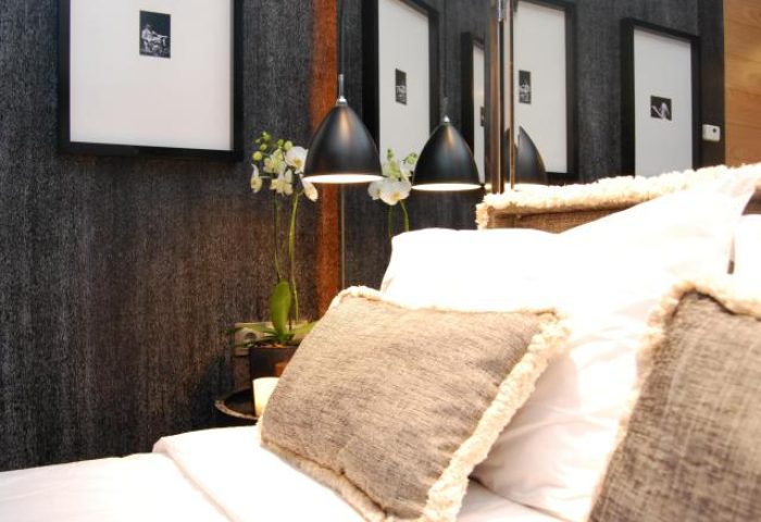 Browns Boutique Hotel room detail. Gay-friendly hotel featuring stylish decor, lamps, pillows, and framed art. Ideal for gay men travel.