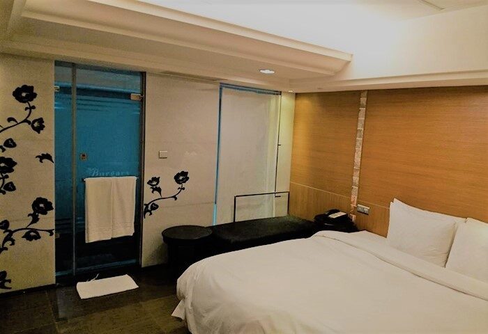 Burgary Hotel room. Gay-friendly hotel with a bed, shower, and floral design. A comfortable and stylish space for gay travelers. Burgary Hotel.