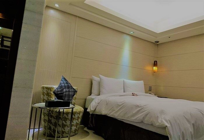 Burgary Hotel's guest room. Gay-friendly hotel with modern decor, a comfy bed, and a stylish side table. A welcoming space for gay travelers.