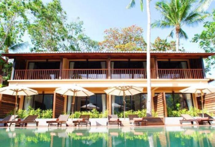 Buri Rasa Koh Phangan gay-friendly hotel view. Poolside rooms with balconies, sunbeds, and umbrellas. Tropical resort for gay travelers.