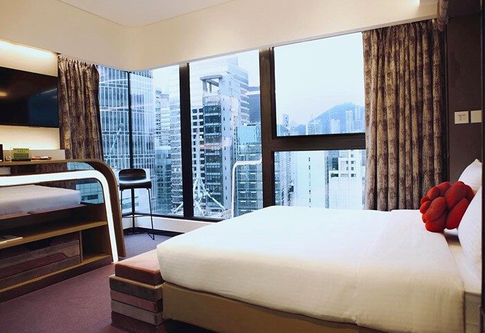 LKF Boutique Hotel Central room. Gay-friendly hotel with city view. Modern design, bed, and window overlooking Hong Kong. Butterfly on LKF hotel.