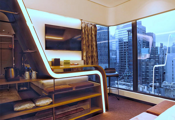 LKF Boutique Hotel Central room. Gay-friendly hotel with modern design, shelves, TV, and city view. Perfect for gay travel in Hong Kong.