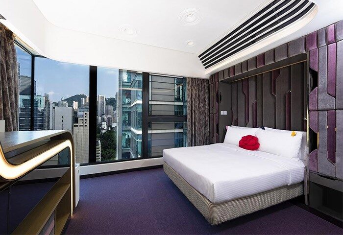 LKF Boutique Hotel Central room. Gay-friendly hotel with city views. Modern design, purple accents, and a comfortable bed. Perfect for gay travel in Hong Kong.