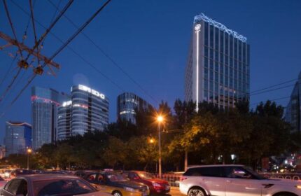 CHAO Sanlitun Beijing hotel exterior at night. This gay-friendly hotel in Beijing offers modern rooms and is near gay nightlife.