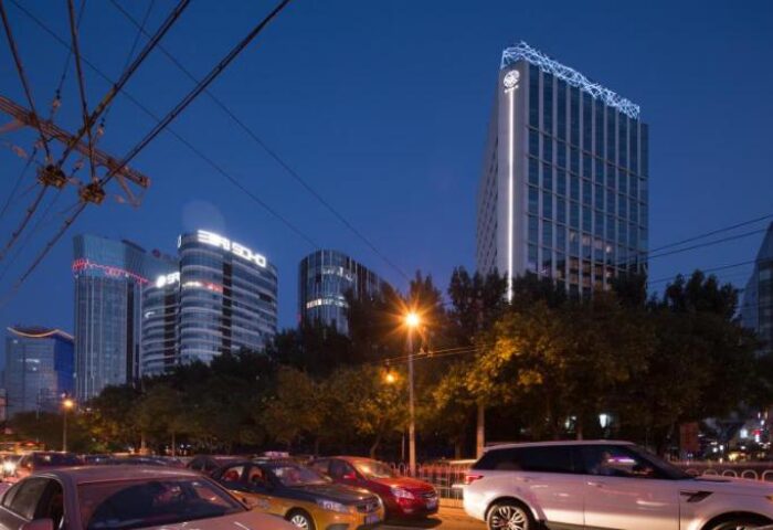 CHAO Sanlitun Beijing hotel exterior at night. This gay-friendly hotel in Beijing offers modern rooms and is near gay nightlife.