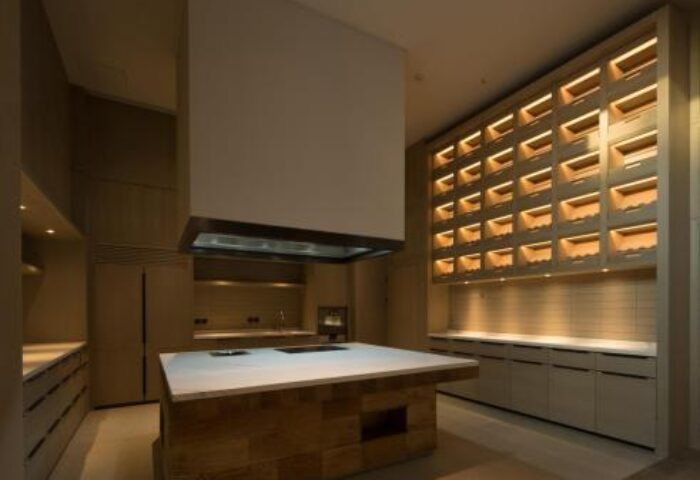 CHAO Sanlitun Beijing hotel kitchen. Gay-friendly hotel kitchen with island, hood, and unique wall storage. Modern design in Beijing, China.
