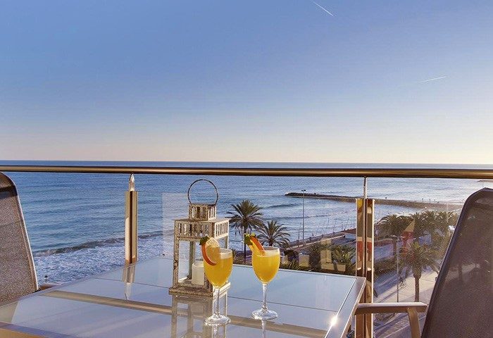 Hotel Calipolis, a gay-friendly hotel: Balcony view with cocktails overlooking the sea. Perfect for gay men's travel and a relaxing vacation.