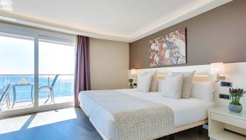Hotel Calipolis gay-friendly room with sea view balcony. Modern bedroom with double bed, ocean view, and stylish decor. Ideal for gay travel.