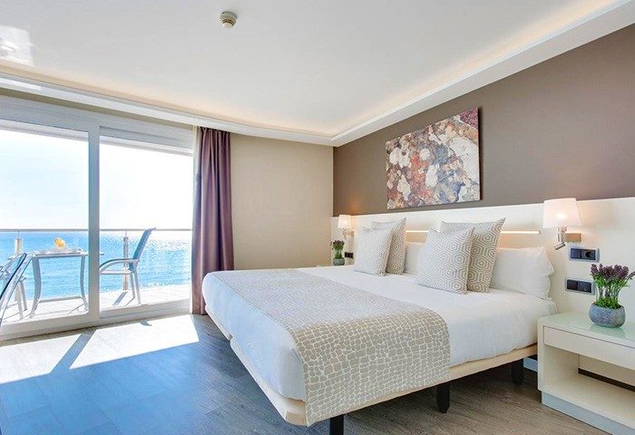 Hotel Calipolis gay-friendly room with sea view balcony. Modern bedroom with double bed, ocean view, and stylish decor. Ideal for gay travel.