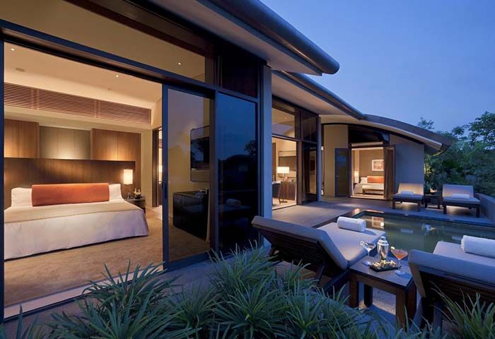 Capella Singapore Hotel's gay-friendly villa. Private plunge pool, luxury bedroom, and outdoor lounge. Perfect for gay travelers seeking comfort.