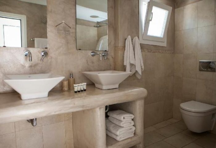 Bathroom at Carbonaki Hotel, a gay-friendly hotel. Double sinks, marble countertop, and neutral tones create a relaxing atmosphere. #Mykonos #GayTravel